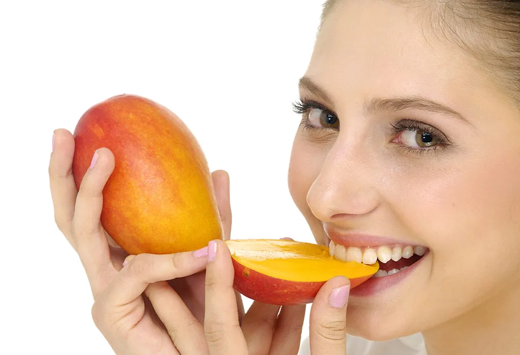 Women eating mango