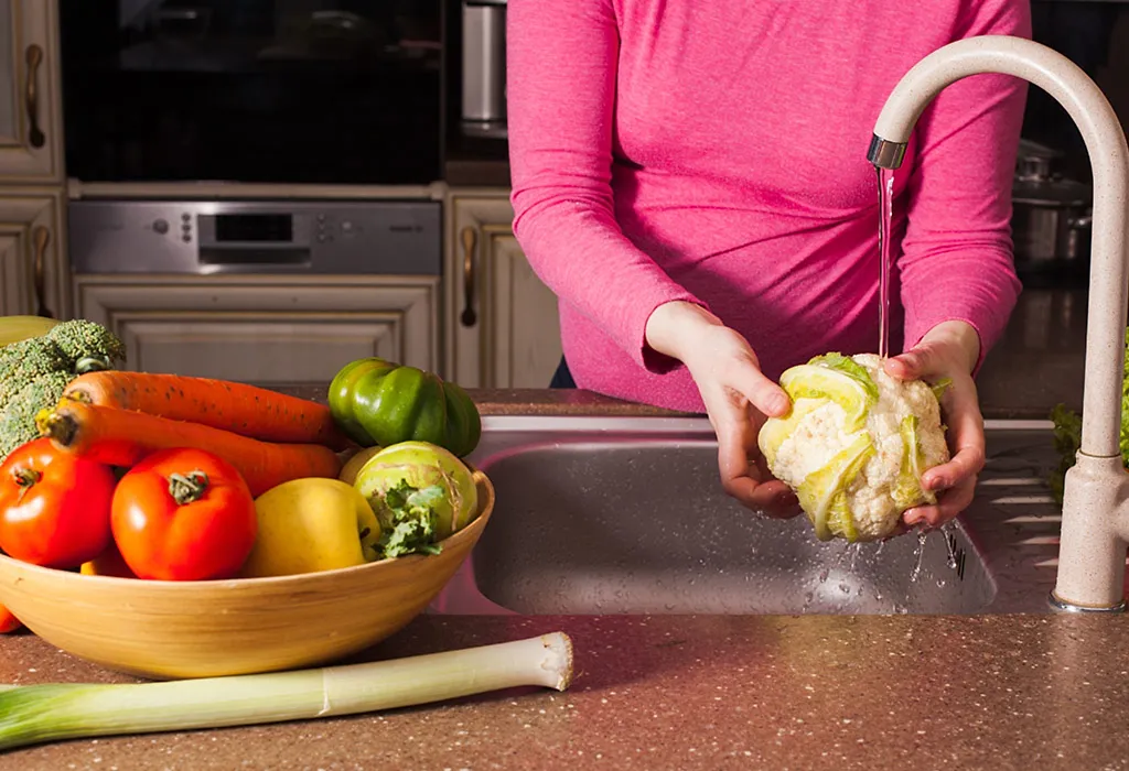 A lady washing cauliflower