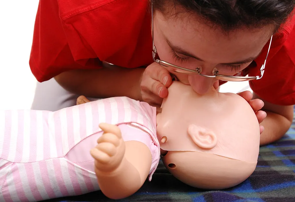 Giving rescue breaths to the infant