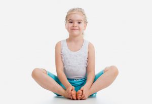 child doing butterfly pose