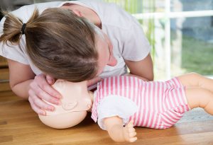 checking for signs of breathing in infant