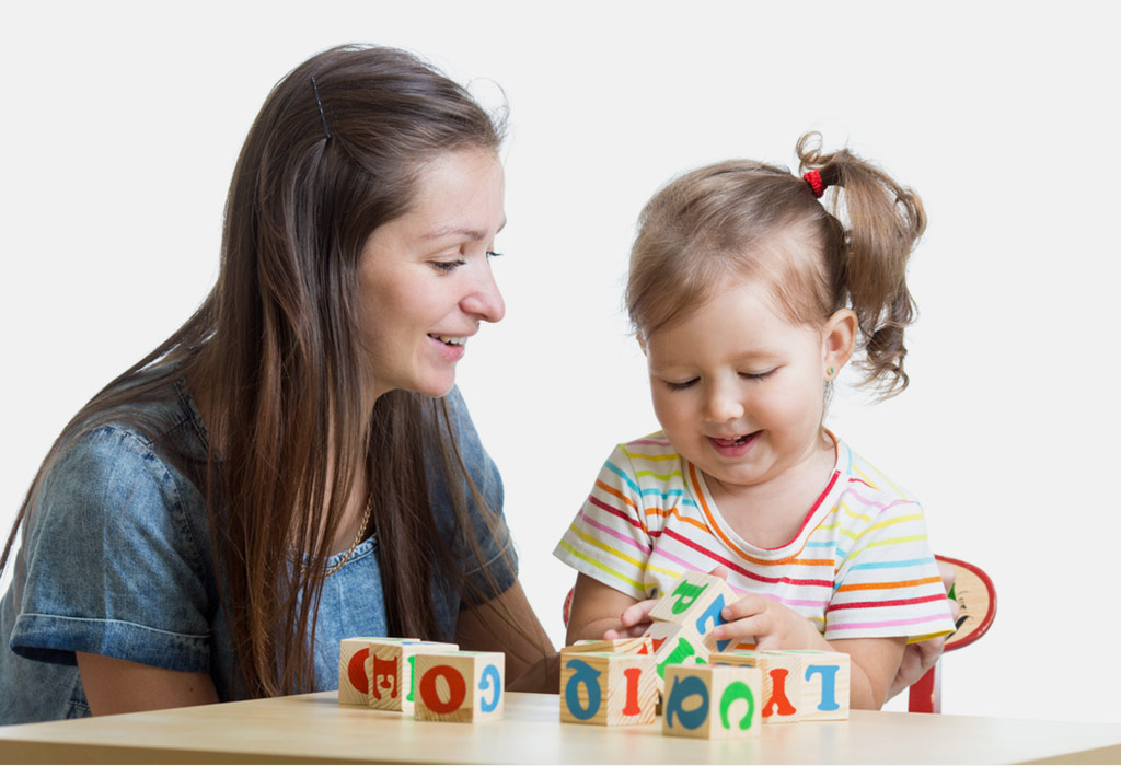 mother teaches letters using blocks