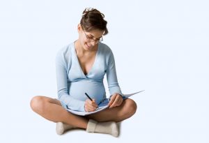 Pregnant woman writing birth plan