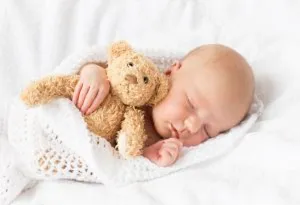 baby sleeping with a toy