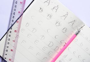 the child practice handwriting alphabet with pencil
