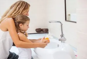 child washing her hands