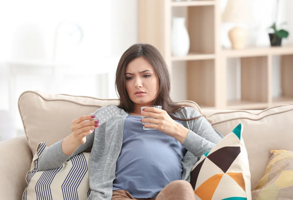 Woman taking vitamin pills