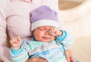 Baby rubbing his eyes