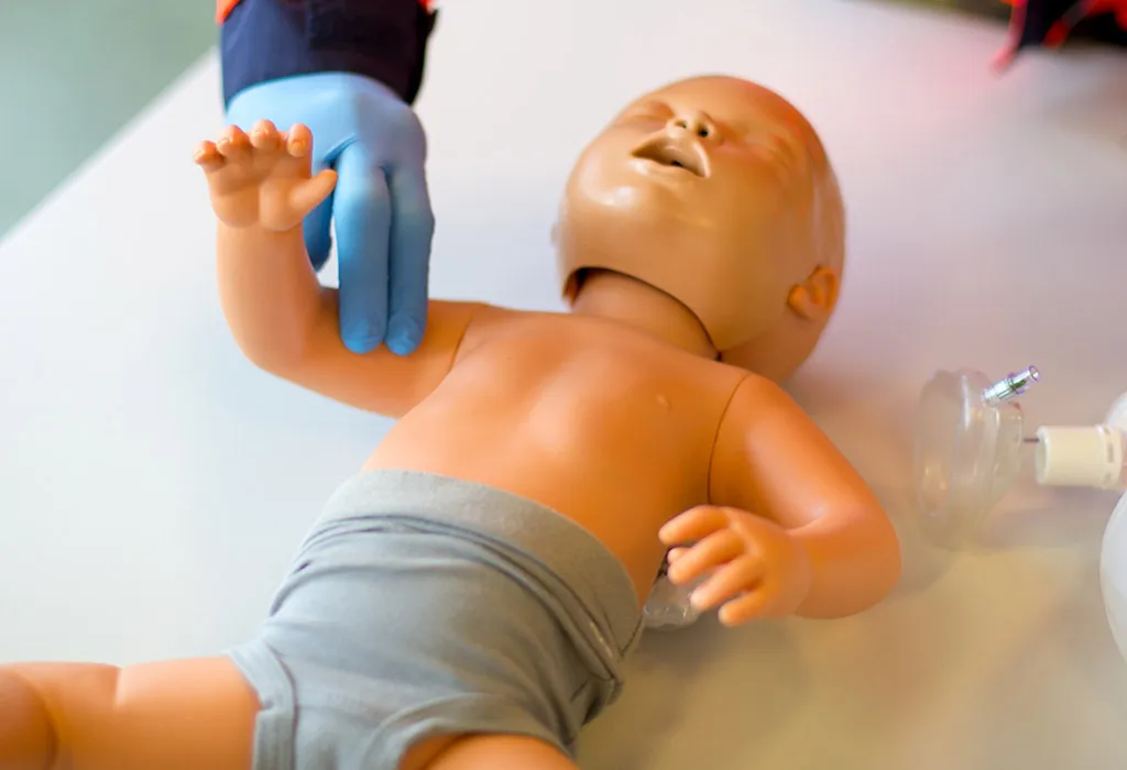 Checking pulse rate of the infant
