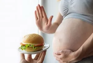 pregnant woman avoiding burger