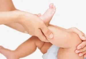 Massaging baby's legs and feet