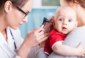 doctor examining baby ear