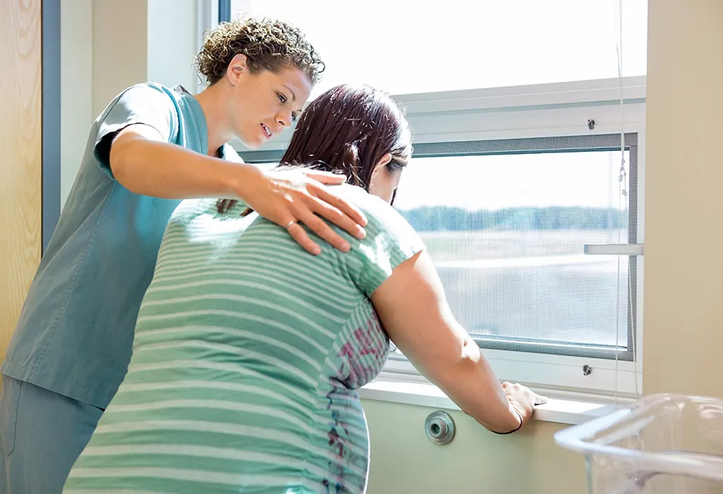 Pregnant woman being helped by nurse