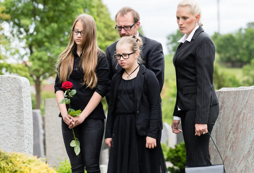 Sad girl at a funeral with family