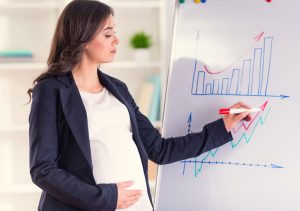 Pregnant woman standing position in office