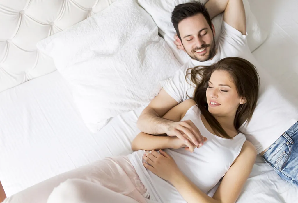 Young wife and husband in bed
