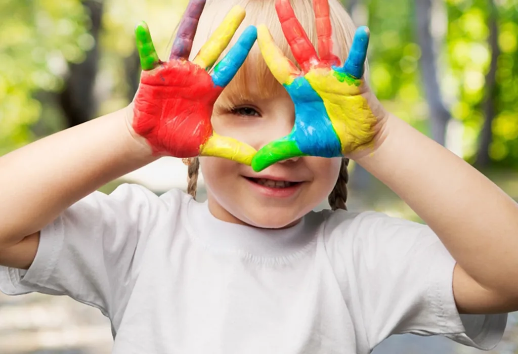 Child playing with colours