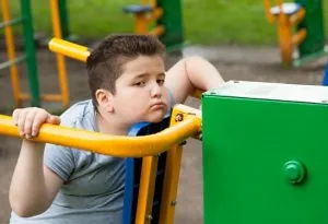 Obese tired child in park