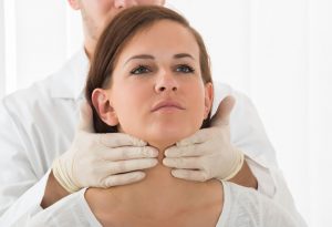 Doctor Examining Thyroid Function