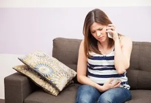 Pregnant woman calling the doctor