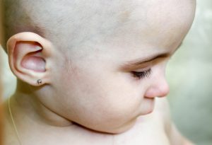 Baby with ear piercing