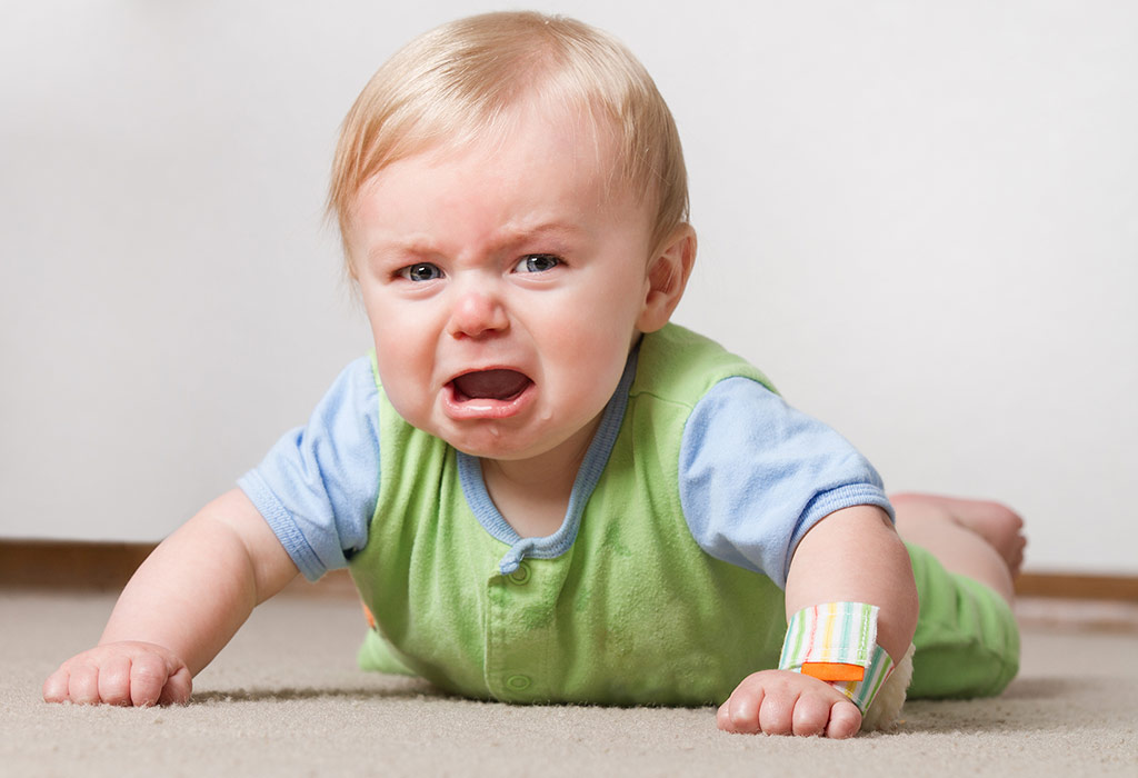 Baby crying while crawling on the floor