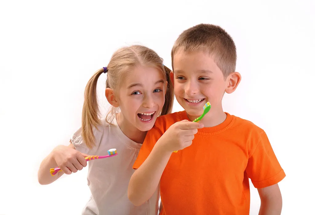 A little girl and  a boy brushing their teeth