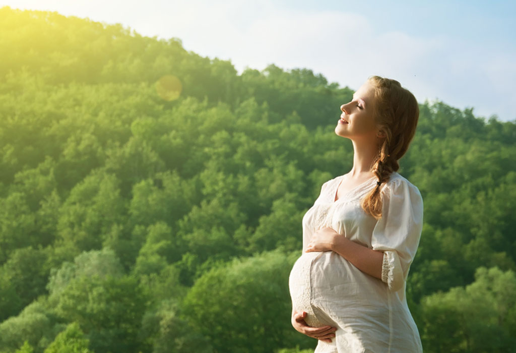 Pregnant woman relaxing in nature