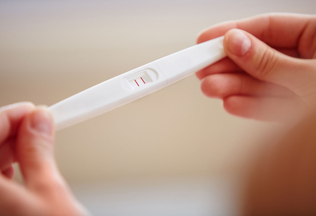 A woman holding a pregnancy test kit