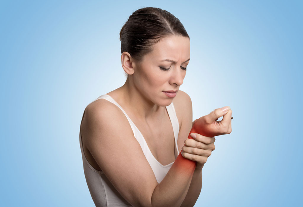 A woman holding her wrist in pain