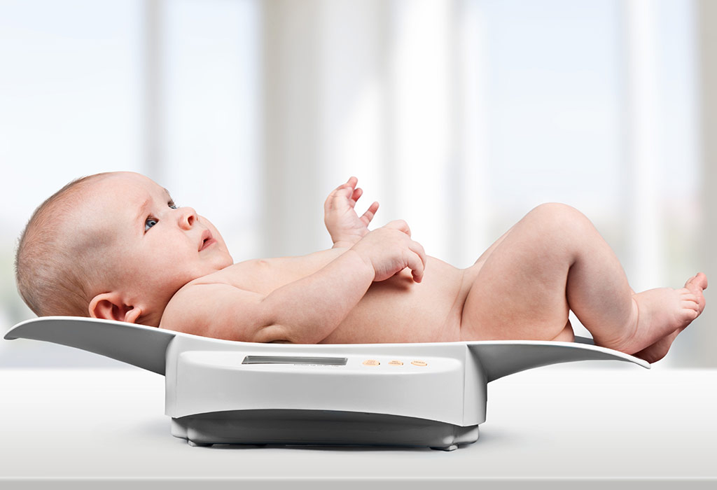 A baby on a weighing scale at the doctor's clinic