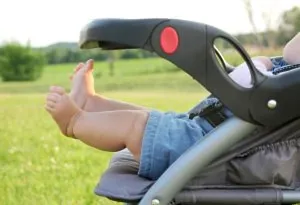 A baby in the stroller in the country side