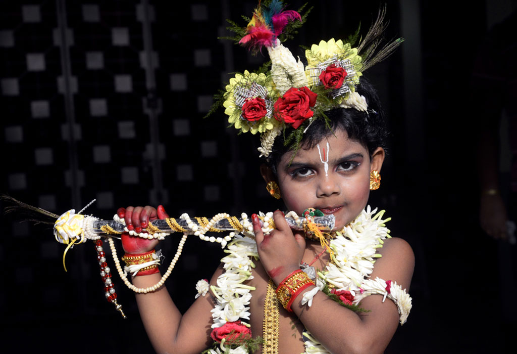 A little boy dressed as Lord Krishna