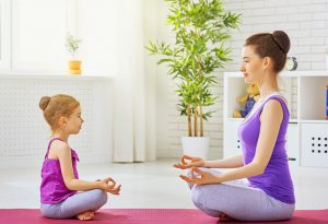 A mother and daughter doing yoga