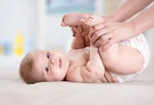 A mother giving a massage to her baby