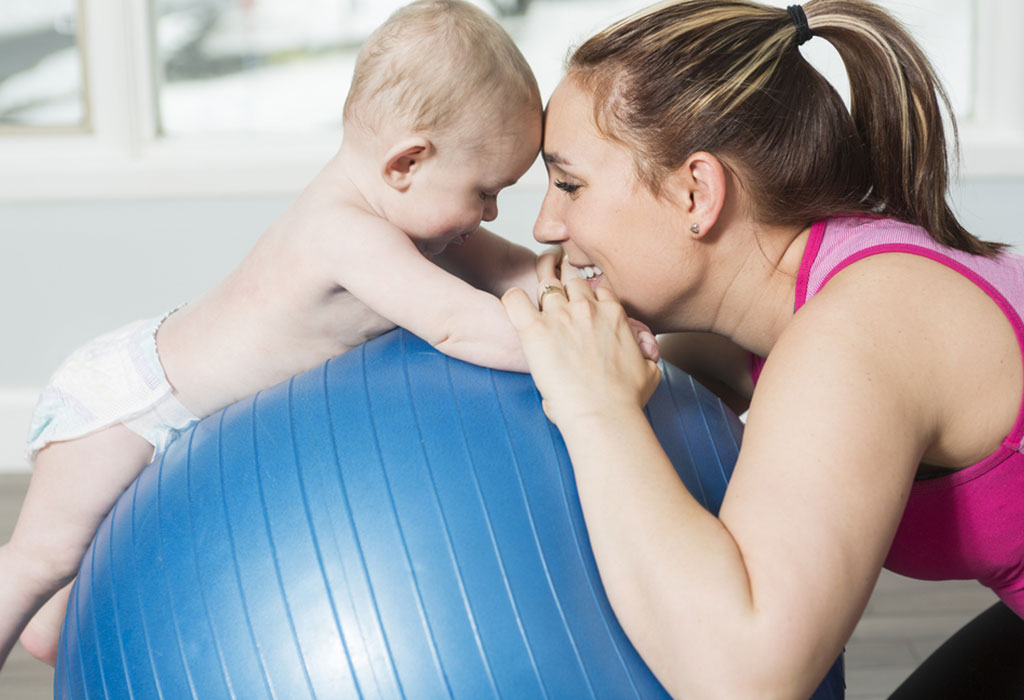 Mother and baby with pilates ball