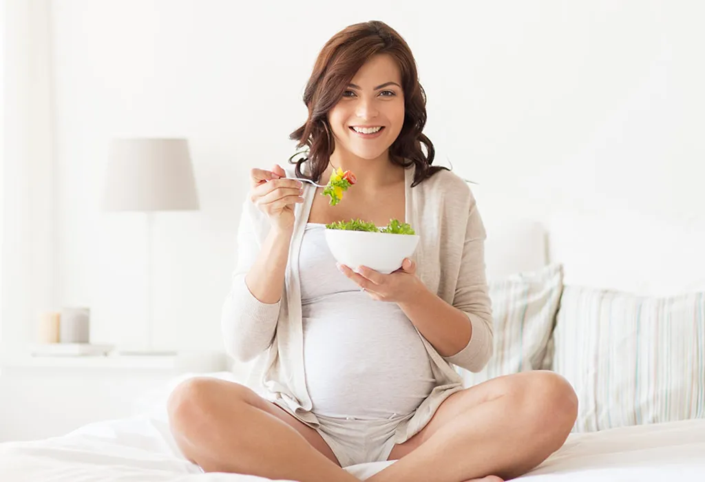 Pregnant woman eating greens