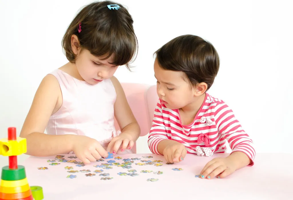 2 children solving puzzle