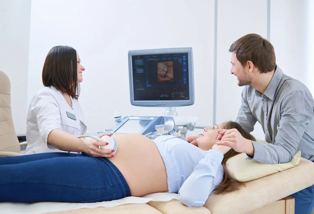 A pregnant woman going through an ultrasound procedure with her husband