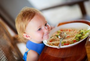 Adorable toddler girl eating food