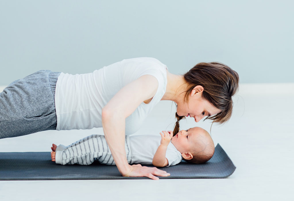 Mother doing planks with her baby