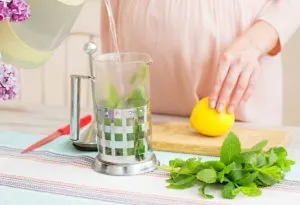 Pregnant woman making a lemon drink