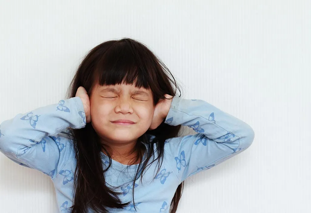 A girl closing her ears and eyes