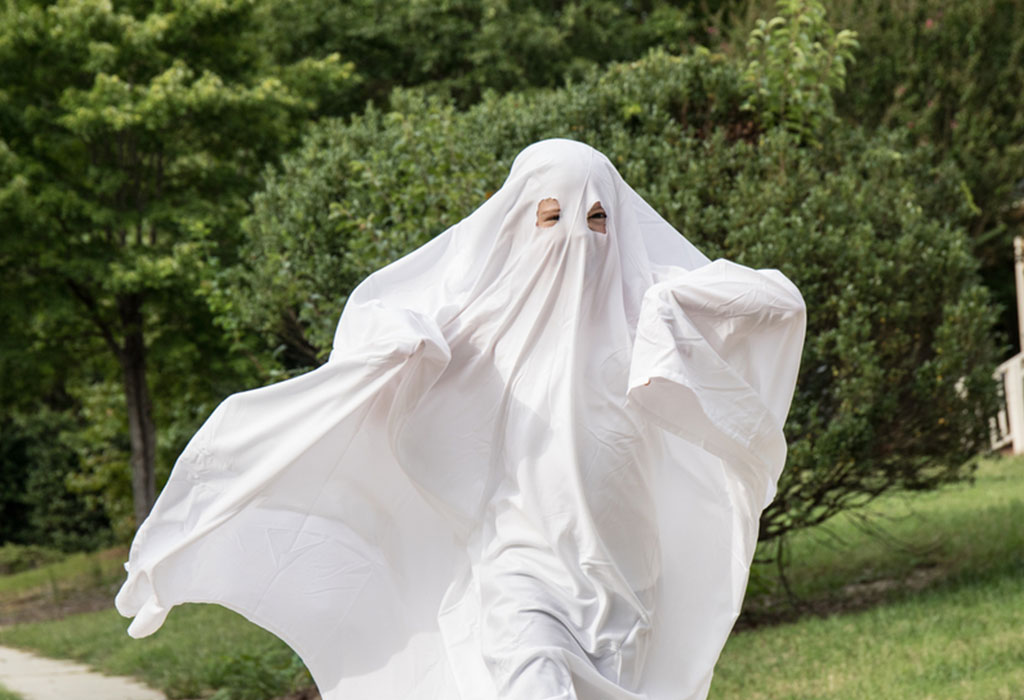 A child in a ghost's costume