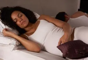 A pregnant woman trying to sleep
