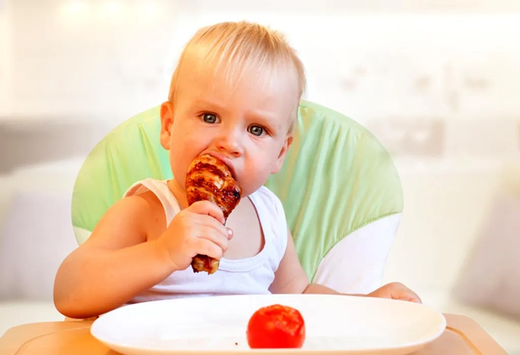Baby eating chicken