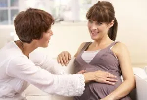 A pregnant woman getting support from a midwife