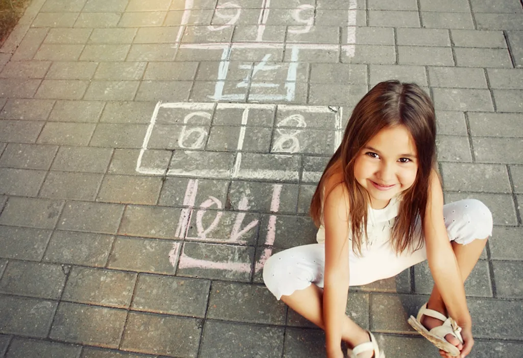 A girl playing hopscotch