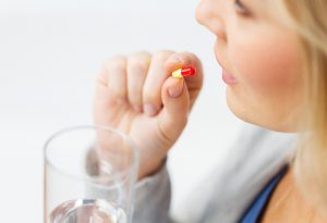Woman taking antibiotic