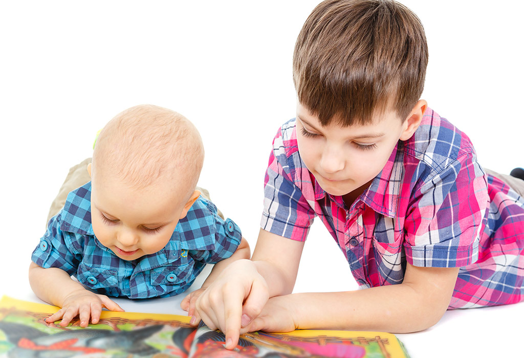 Two kids reading a book